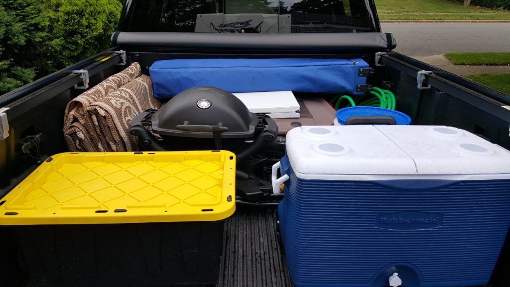 organize your camping cooler and accessories in back of the truck