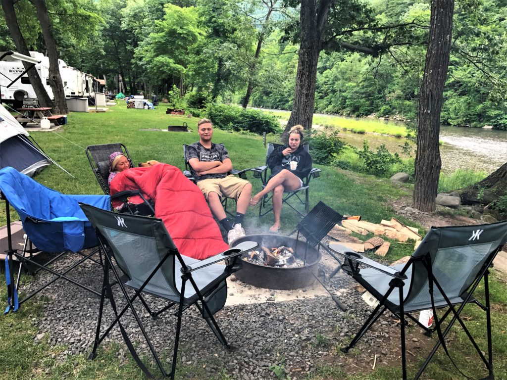 family sitting around the campfire