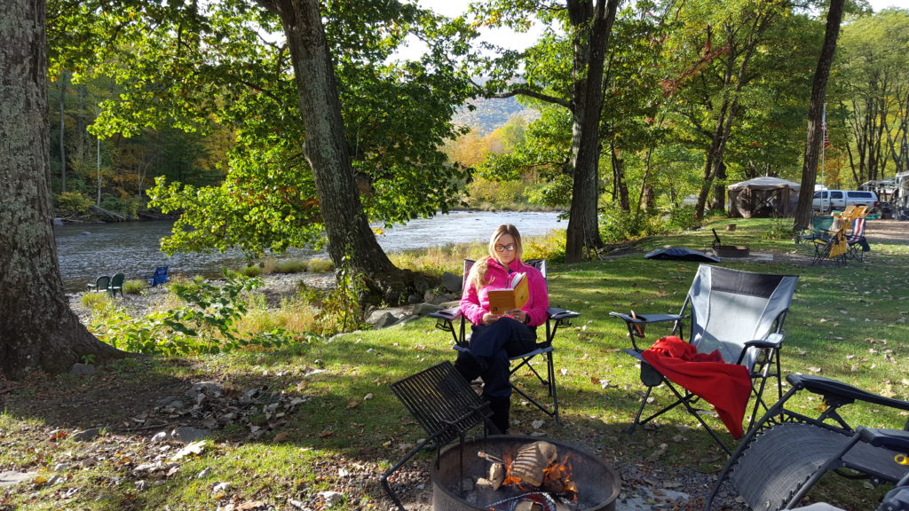 relaxing by the river at a campground