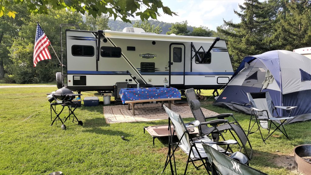 RV Campground set up with travel trailer and tent