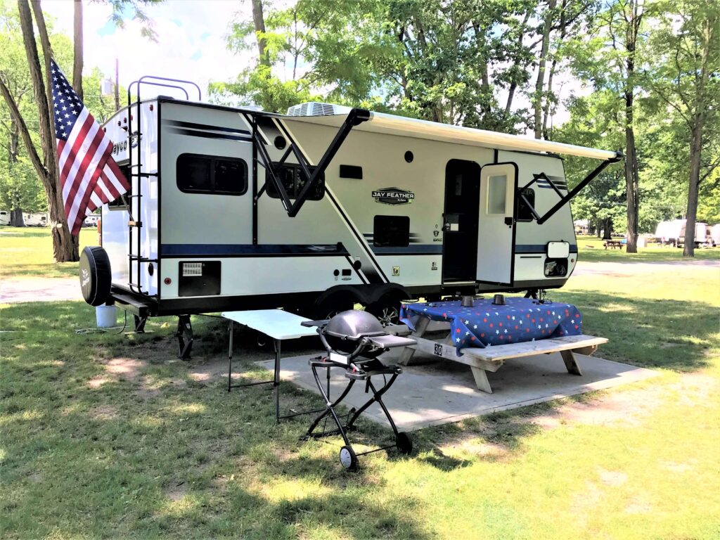 travel trailer set up at campground