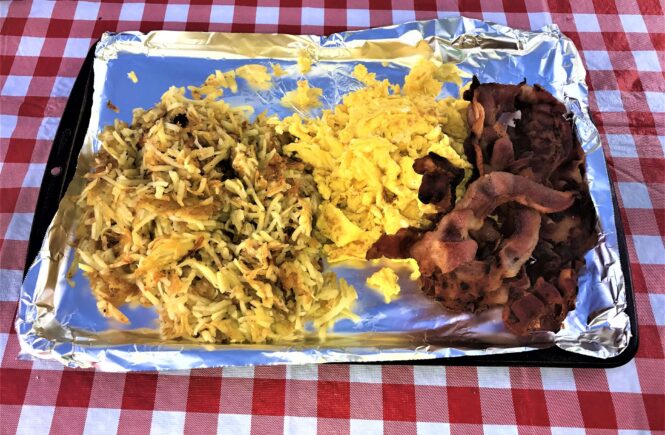 Hashbrowns eggs and bacon cooked on a Blackstone Grill at the campground